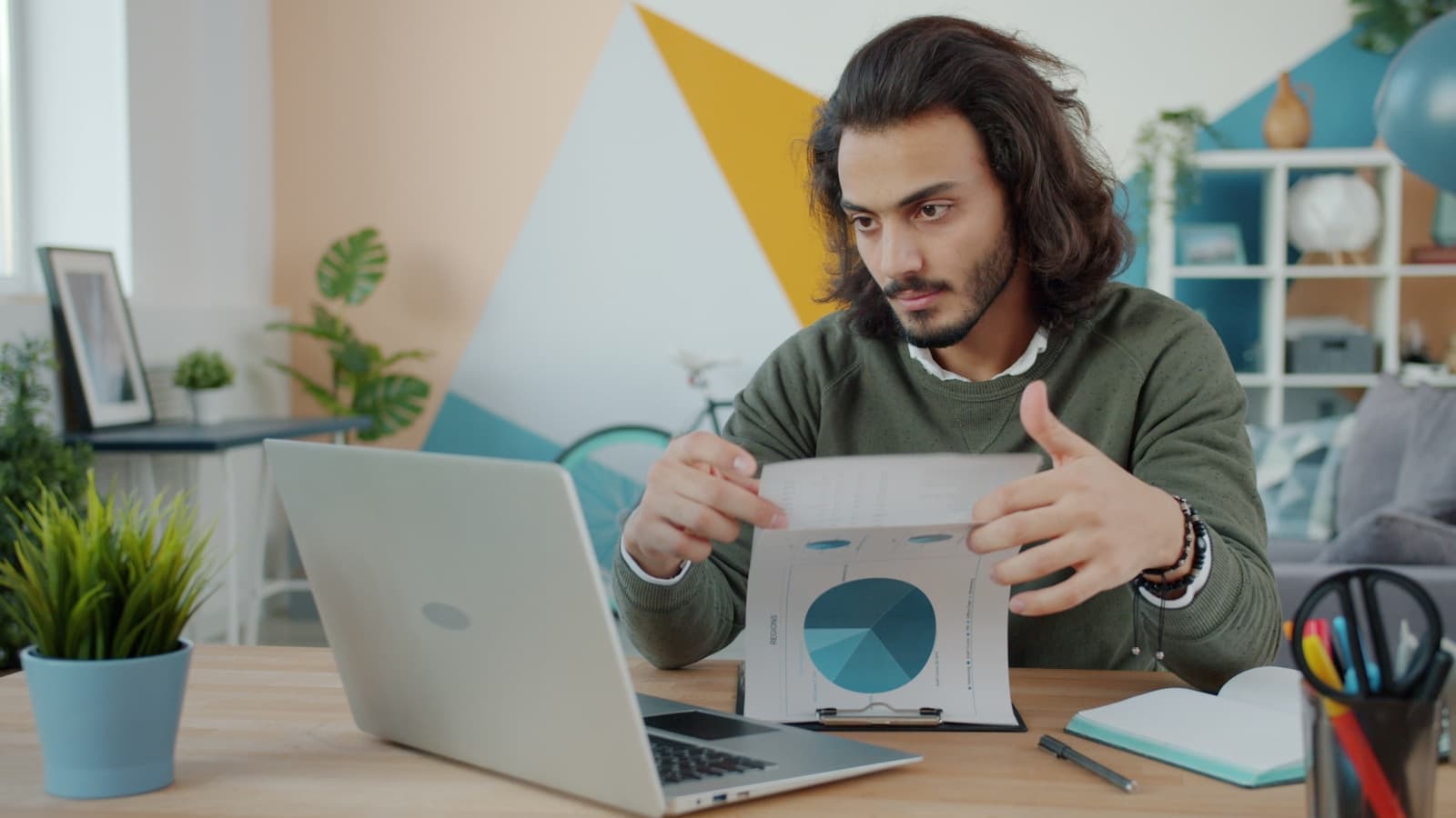 A professional reviewing case study examples on a laptop