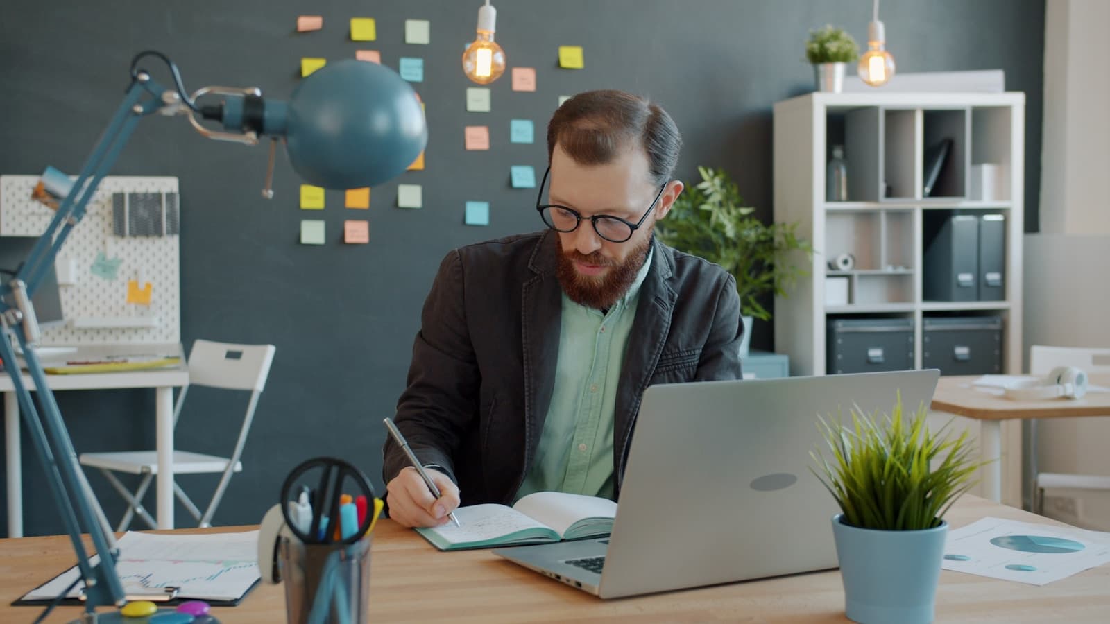 A professional writing a case study at their desk