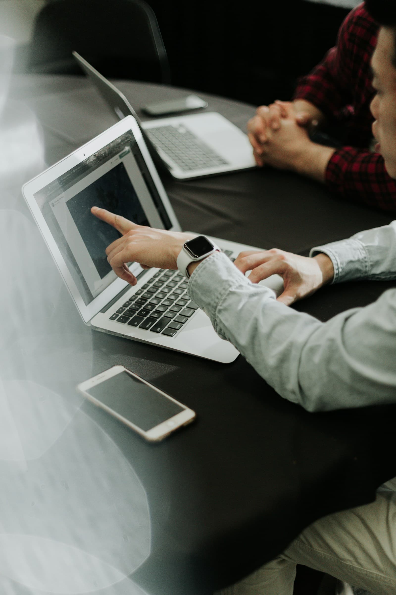 A consultant reviewing a client success story on a laptop